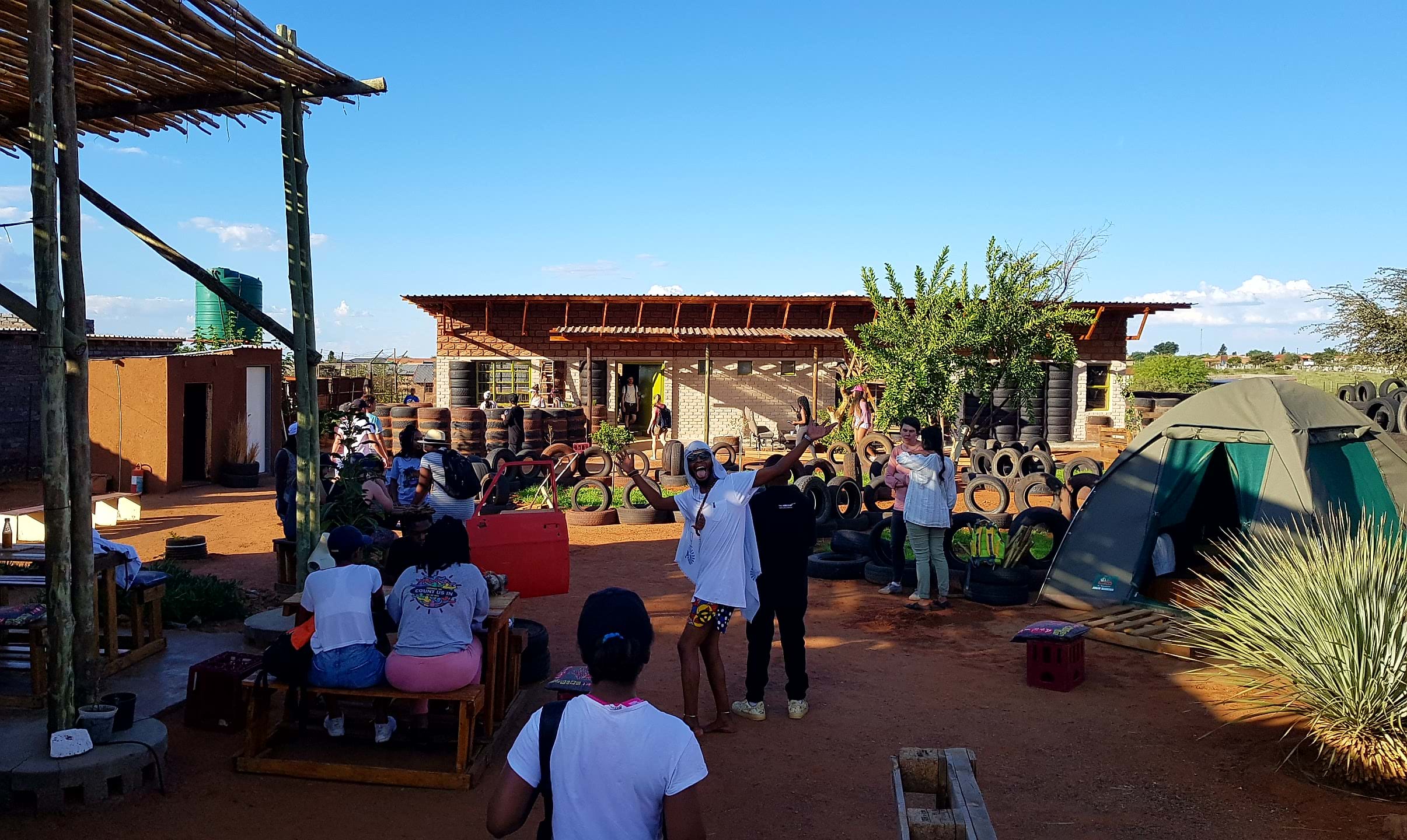Visitors in the outdoor courtyard at The Workshop ko Kasi in Mothibistad